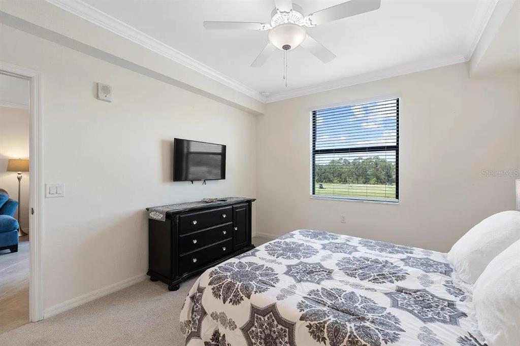 17724 Gawthrop Drive, Unit 204 Bradenton, FL 34211 - Photo 25 of 55 a bedroom with a bed and a flat tv screen on dresser