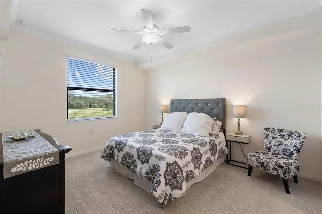 17724 Gawthrop Drive, Unit 204 Bradenton, FL 34211 - Photo 26 of 55 a bedroom with a bed and a chandelier