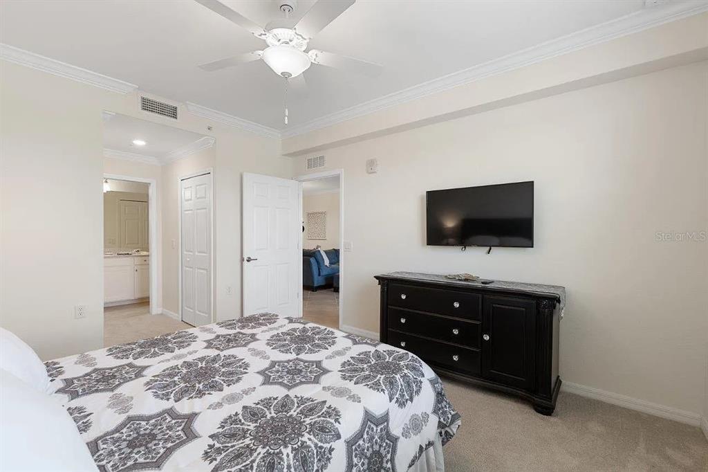 17724 Gawthrop Drive, Unit 204 Bradenton, FL 34211 - Photo 27 of 55 a bedroom with a bed and a flat screen tv