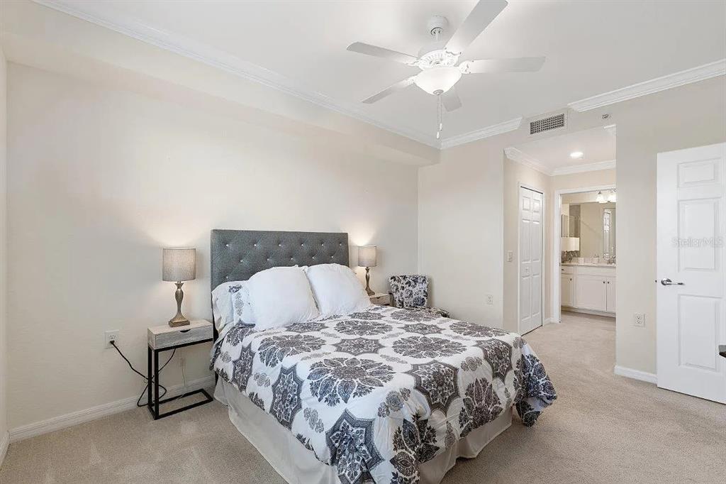 17724 Gawthrop Drive, Unit 204 Bradenton, FL 34211 - Photo 28 of 55 a bedroom with a bed and a chandelier