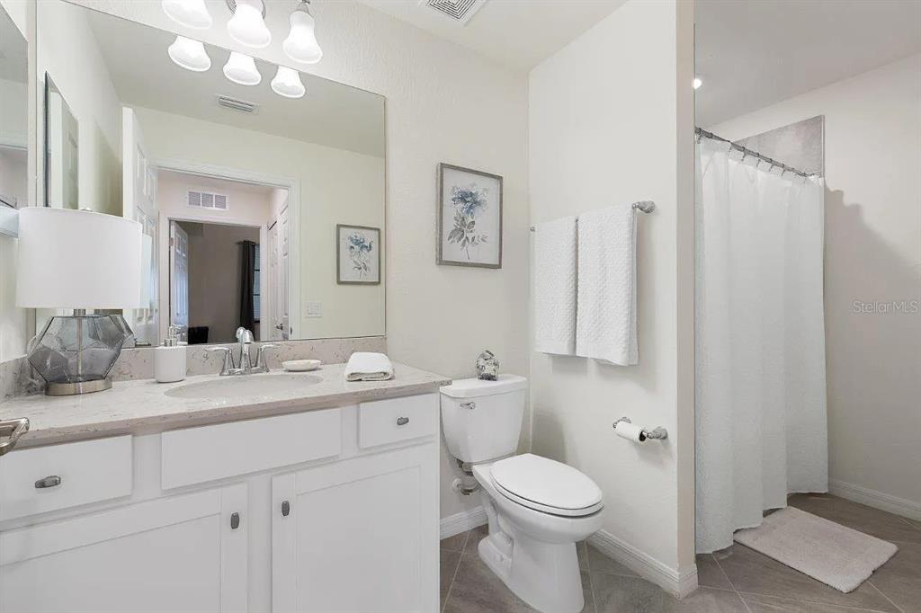 17724 Gawthrop Drive, Unit 204 Bradenton, FL 34211 - Photo 31 of 55 a bathroom with a toilet a sink and mirror
