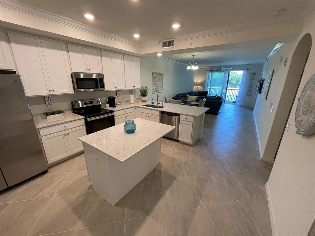 17724 Gawthrop Drive, Unit 204 Bradenton, FL 34211 - Photo 55 of 55 a kitchen with a sink a counter top space stainless steel appliances and cabinets