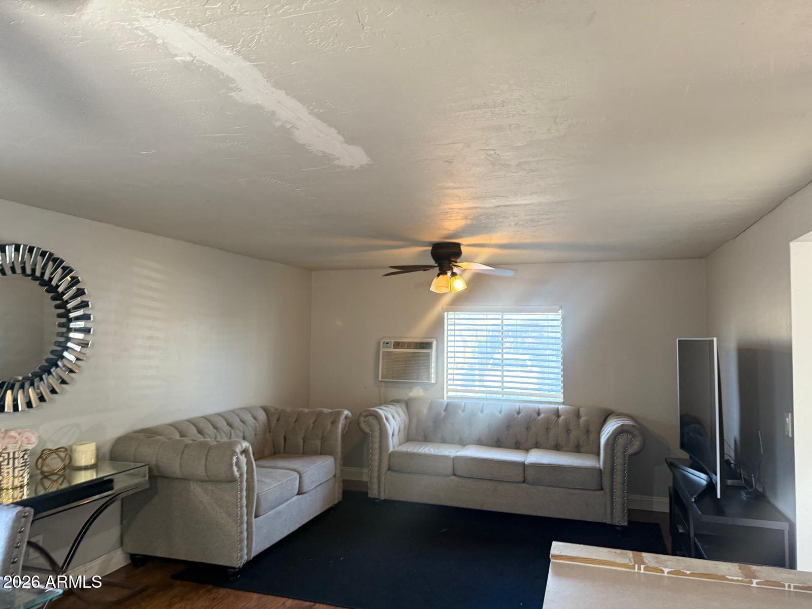 130 East McKellips Road, Unit 47 Mesa, AZ 85201 - Photo 6 of 6 a living room with furniture and a window