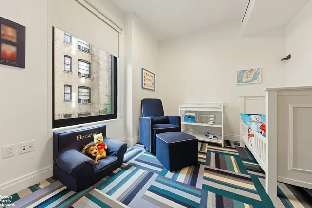 a living room with furniture and a bookshelf