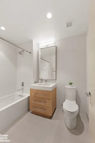 a bathroom with a granite countertop toilet a sink and bathtub
