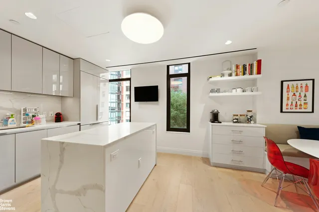 a kitchen with a sink cabinets and window