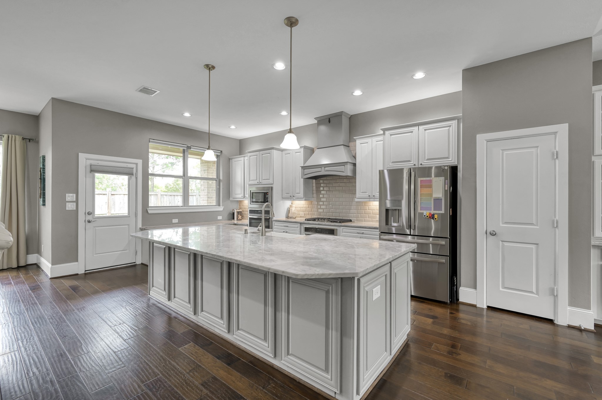 31714 Pierwood Court Spring, TX 77386 - Photo 16 of 49 a kitchen with stainless steel appliances granite countertop a sink a stove a refrigerator cabinets and wooden floor