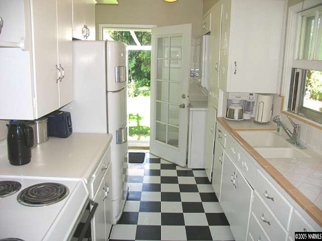 861 Primrose Street Reno, NV 89509 - Photo 7 of 9 a kitchen with a refrigerator a sink and a stove