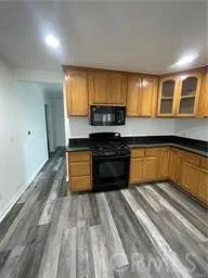 a kitchen with a refrigerator and a stove top oven