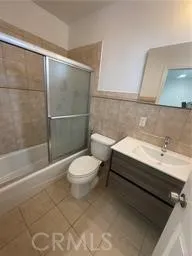 a bathroom with a toilet a sink and shower