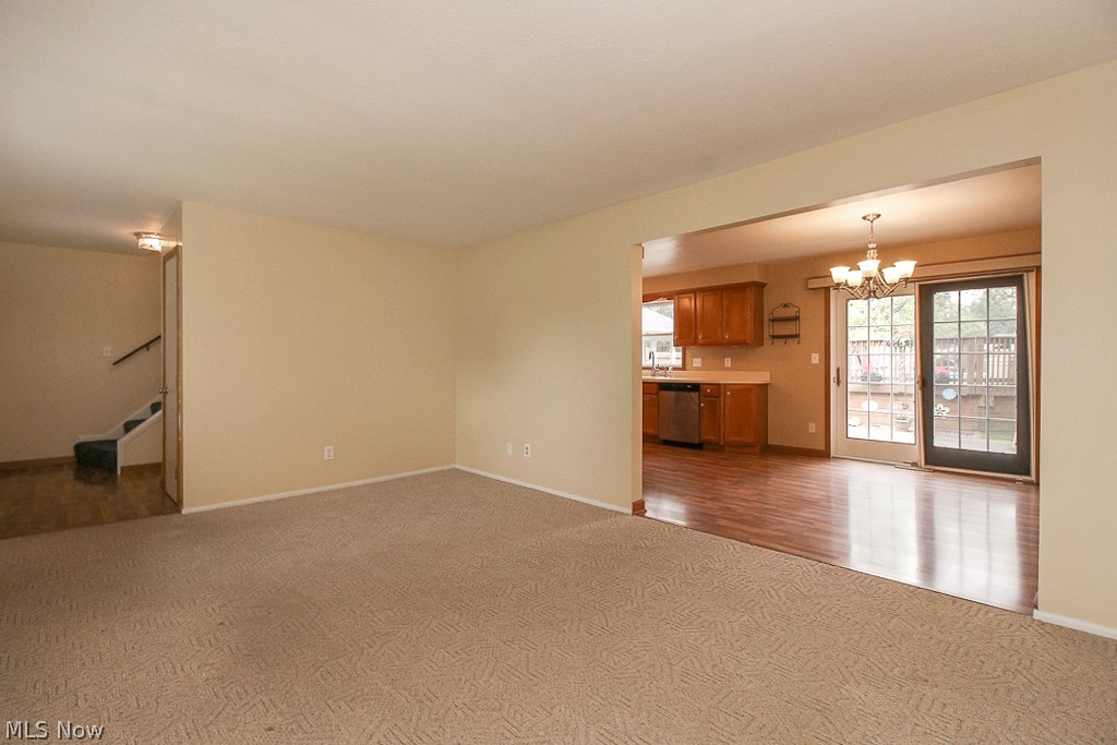 989 Millridge Road Cleveland, OH 44143 - Photo 3 of 35 The formal living room opens into the large eat-in kitchen.