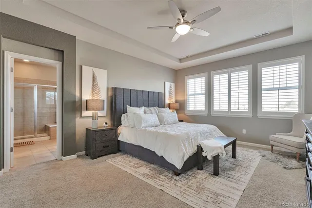 a spacious bedroom with a bed and a chandelier