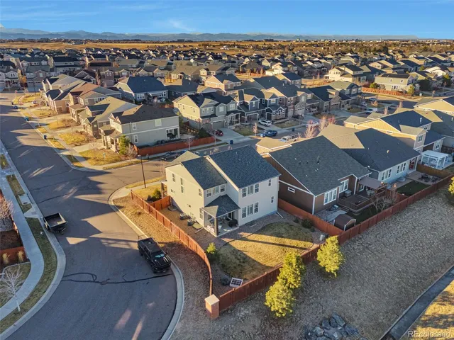 an aerial view of a swimming pool with outdoor seating