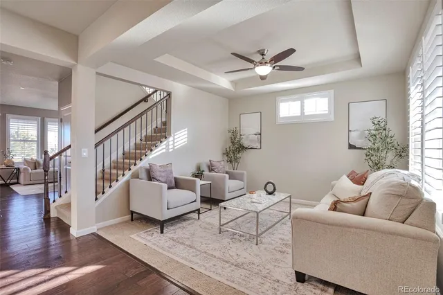 a living room with furniture and a chandelier