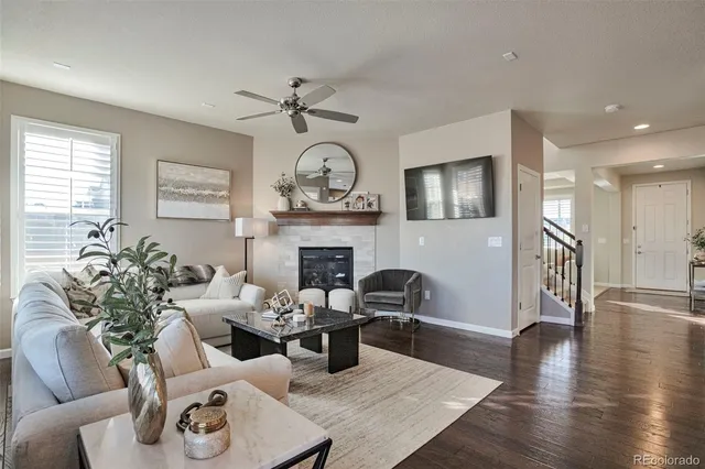 a living room with furniture kitchen view and a fireplace