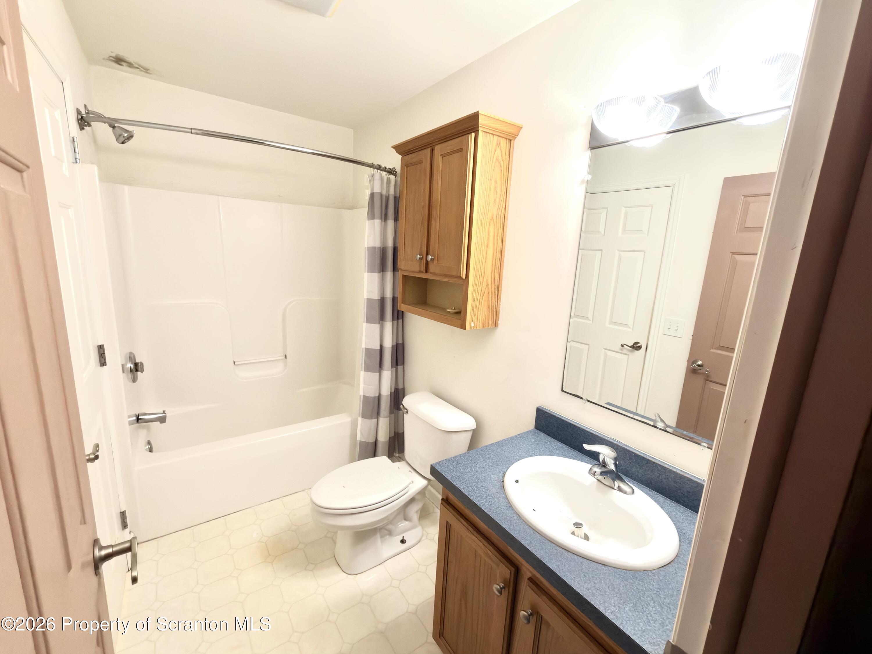 41 South Waterford Road Dalton, PA 18414 - Photo 16 of 22 a bathroom with a sink a toilet a tub and shower