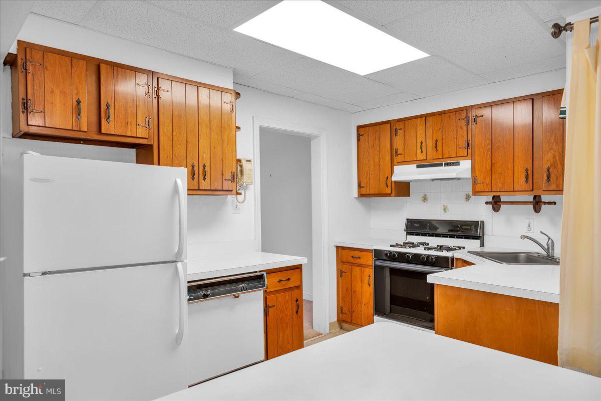263 Hopkins Road Haddonfield, NJ 08033 - Photo 18 of 38 a kitchen with stainless steel appliances a refrigerator sink and stove