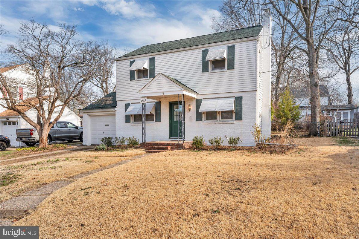 263 Hopkins Road Haddonfield, NJ 08033 - Photo 2 of 38 a front view of a house with a yard and garage