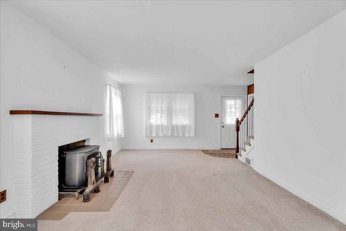 263 Hopkins Road Haddonfield, NJ 08033 - Photo 6 of 38 an empty room with fireplace and windows