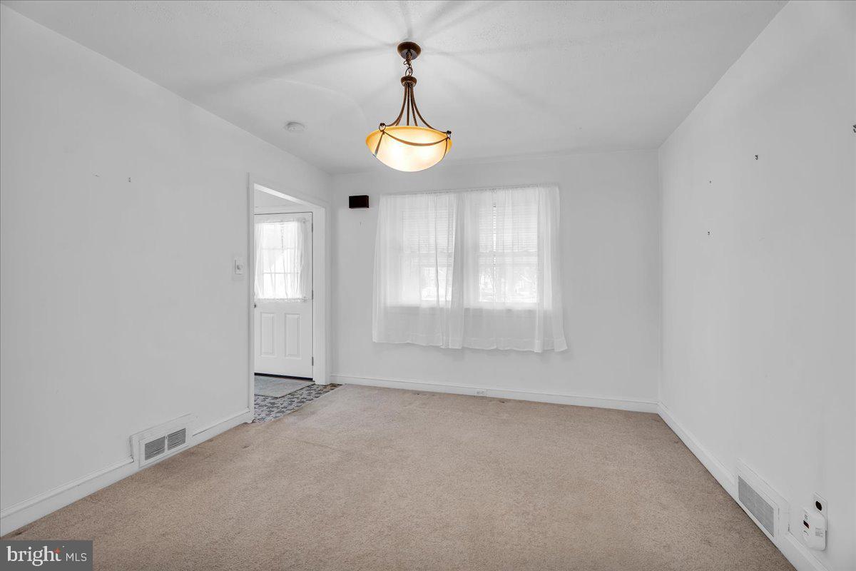 263 Hopkins Road Haddonfield, NJ 08033 - Photo 8 of 38 an empty room with windows and chandelier fan