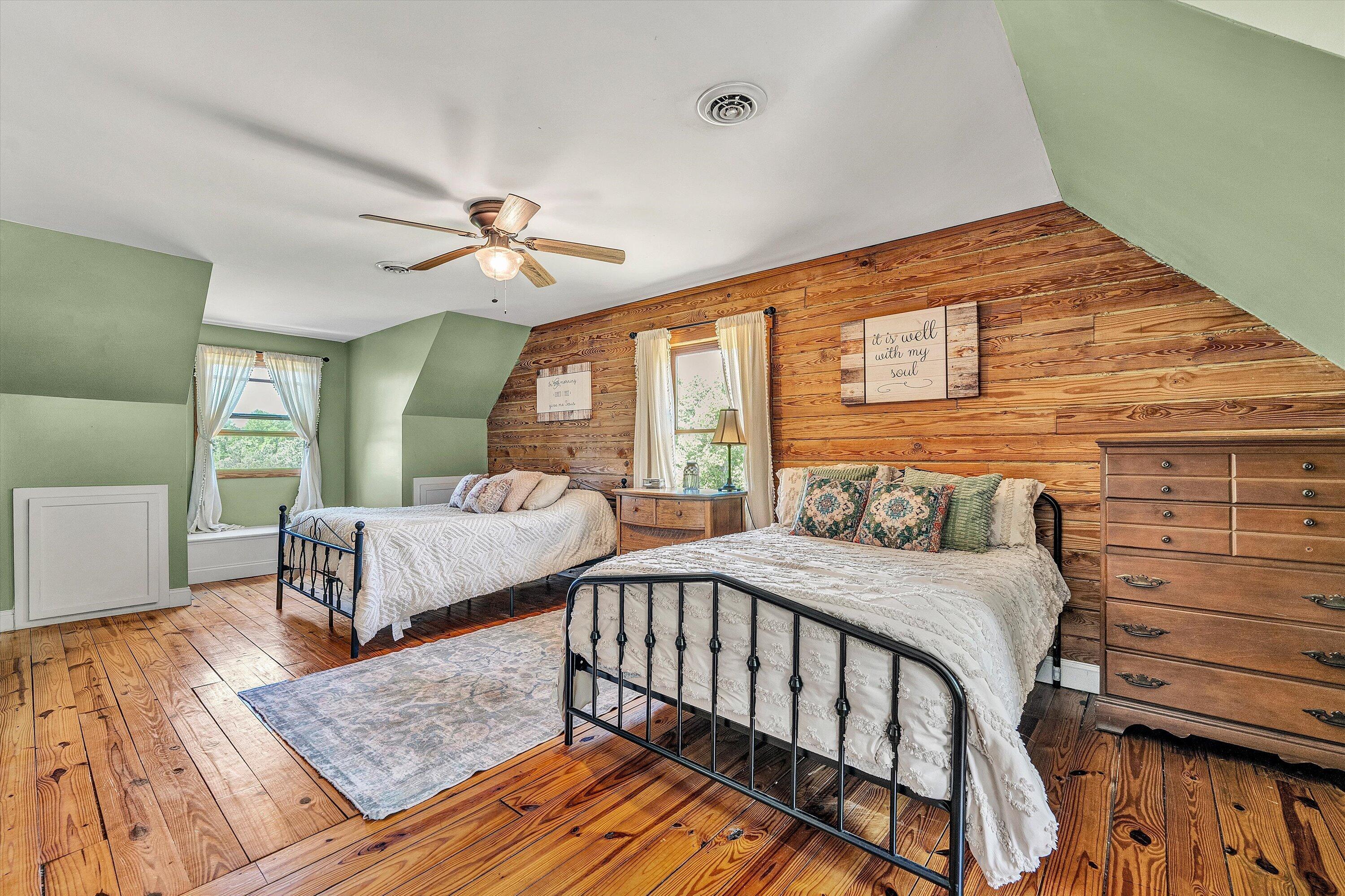 180 Thompson Ridge Circle Ferrum, VA 24088 - Photo 40 of 74 a bedroom with a bed and wooden floor