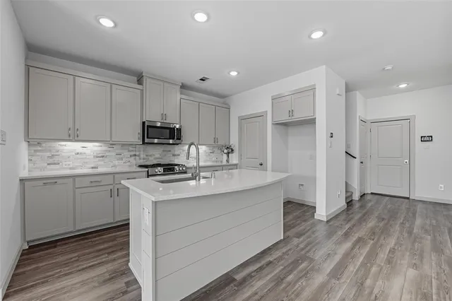 a kitchen with a sink stove and refrigerator