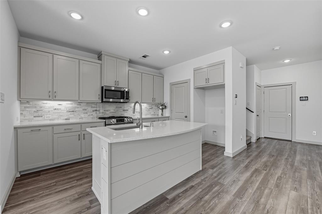 228 Spring Hill Road Flower Mound, TX 75028 - Photo 12 of 31 a kitchen with a sink stove and refrigerator
