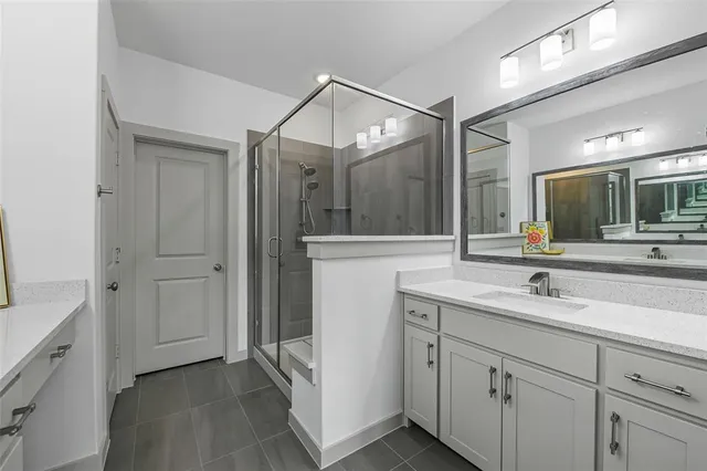 a spacious bathroom with a sink and a mirror