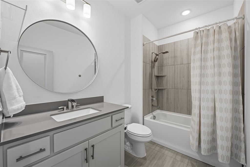 228 Spring Hill Road Flower Mound, TX 75028 - Photo 27 of 31 a bathroom with a sink a toilet and a mirror