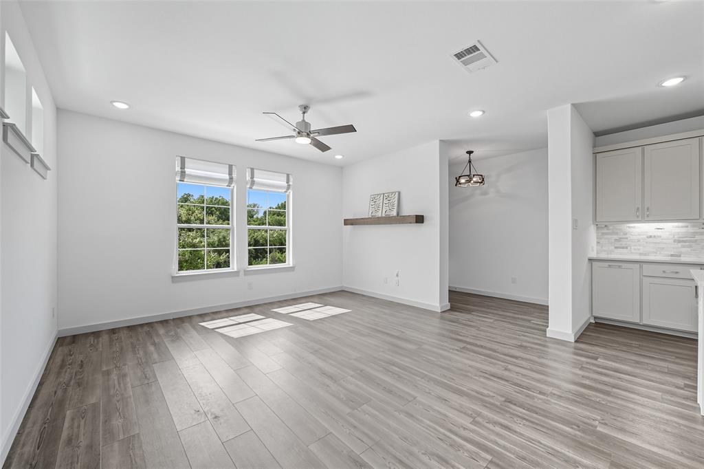 228 Spring Hill Road Flower Mound, TX 75028 - Photo 5 of 31 a view of an empty room with a window and wooden floor
