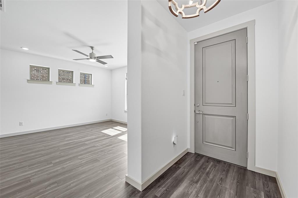 228 Spring Hill Road Flower Mound, TX 75028 - Photo 9 of 31 a view of an empty room with wooden floor and a window