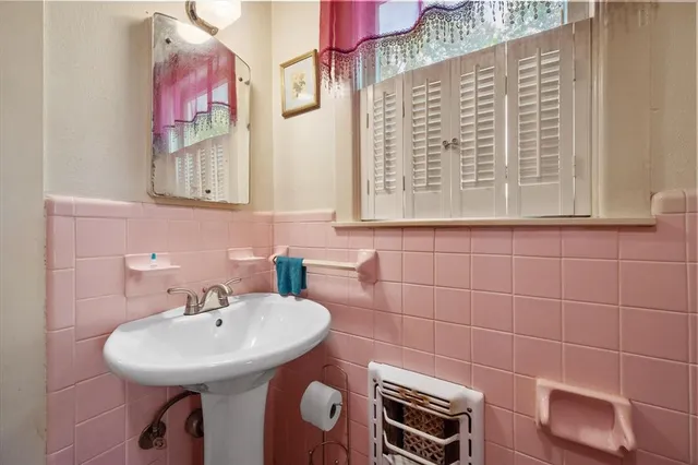 a bathroom with a sink a mirror and a shower