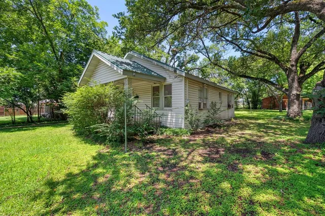 a view of a house with yard and tree s
