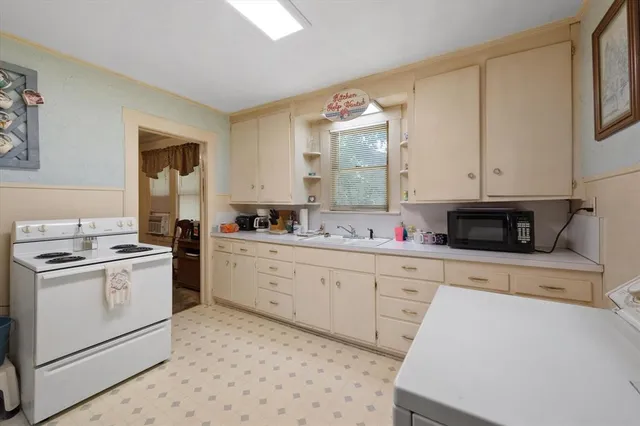 a kitchen with a stove window and cabinets