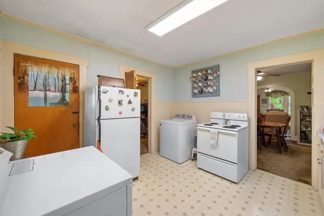 a kitchen with a refrigerator and cabinets