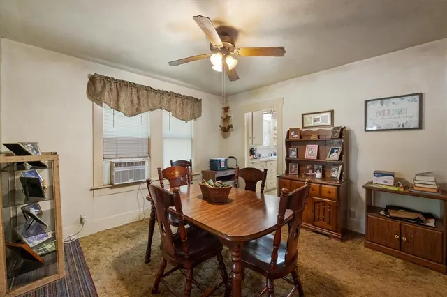 a view of a dining room with furniture and a window