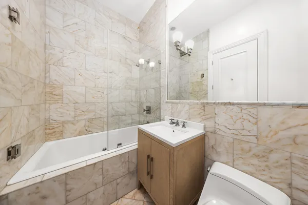 a spacious bedroom with a bed and a fireplace