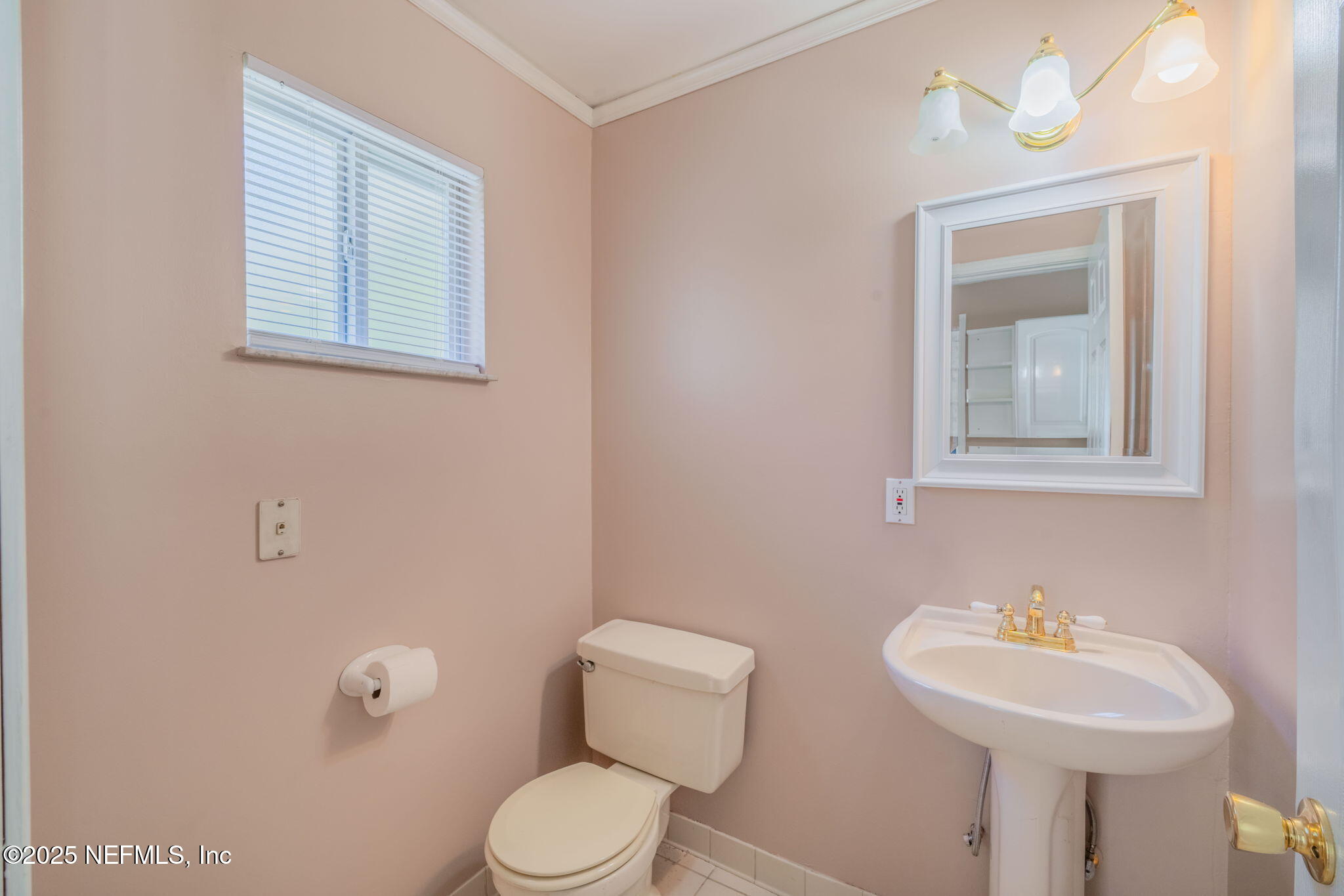 8705 River Park Road St. Augustine, FL 32092 - Photo 31 of 57 a bathroom with a toilet a sink and mirror