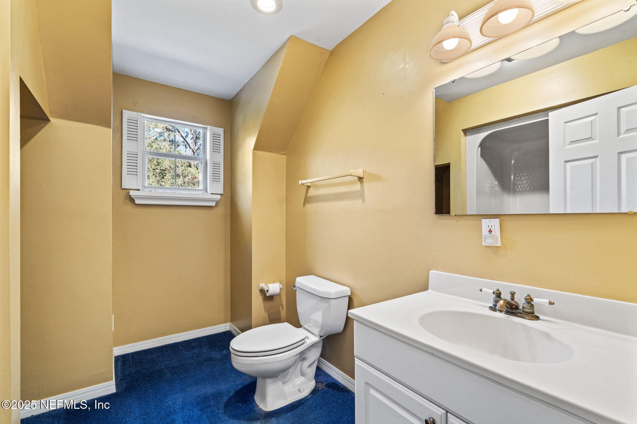 8705 River Park Road St. Augustine, FL 32092 - Photo 40 of 57 a bathroom with a toilet a sink and mirror