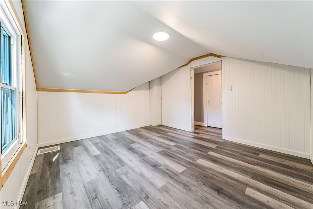 33384 Chestnut Ridge Road North Ridgeville, OH 44039 - Photo 18 of 30 Bonus room featuring wood finished floors, vaulted ceiling, and wood walls