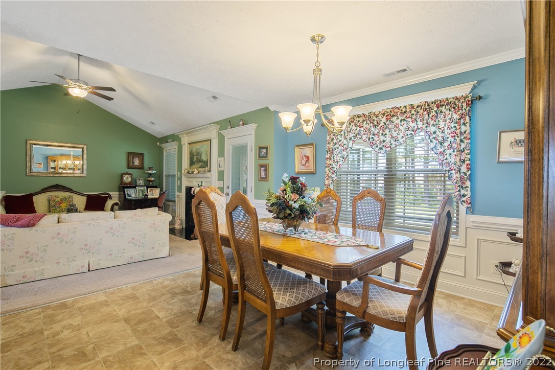 2511 Wade-Stedman Road Stedman, NC 28391 - Photo 11 of 47 a view of a dining room with furniture a chandelier and wooden floor