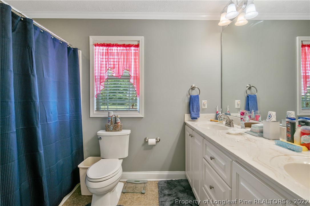 2511 Wade-Stedman Road Stedman, NC 28391 - Photo 23 of 47 a bathroom with a toilet sink and mirror