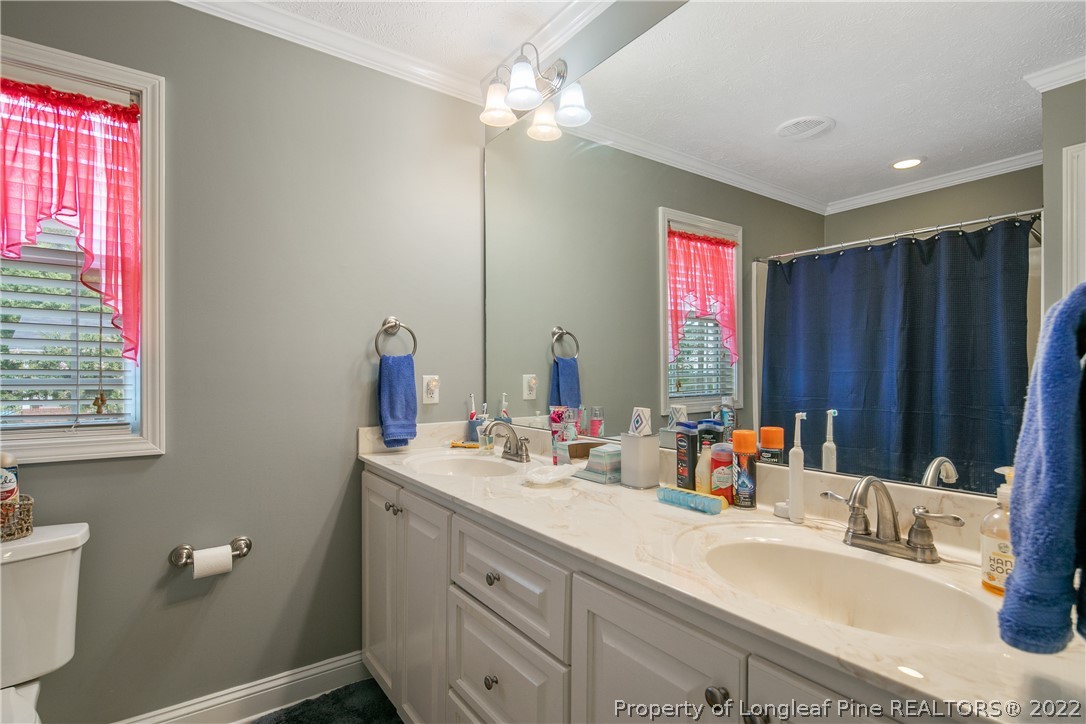2511 Wade-Stedman Road Stedman, NC 28391 - Photo 24 of 47 a bathroom with a double vanity sink a mirror and a window