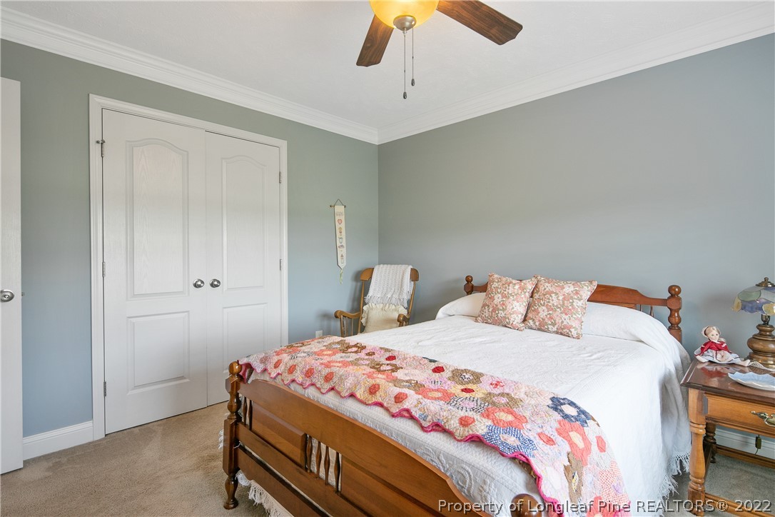 2511 Wade-Stedman Road Stedman, NC 28391 - Photo 30 of 47 a bedroom with a bed and a chandelier
