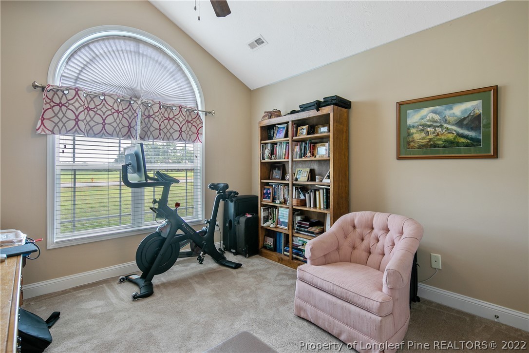 2511 Wade-Stedman Road Stedman, NC 28391 - Photo 31 of 47 a living room with furniture a window and gym equipment
