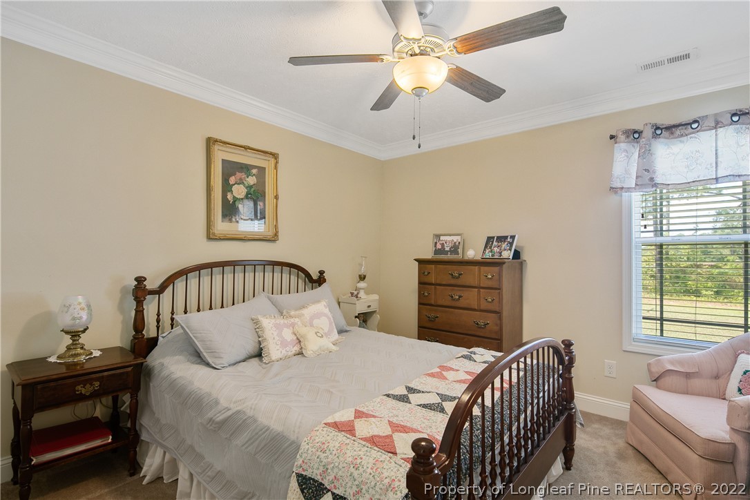 2511 Wade-Stedman Road Stedman, NC 28391 - Photo 35 of 47 a bedroom with a bed and a chandelier