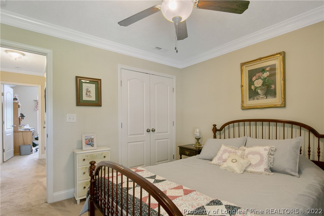 2511 Wade-Stedman Road Stedman, NC 28391 - Photo 38 of 47 a bedroom with a bed and a chandelier