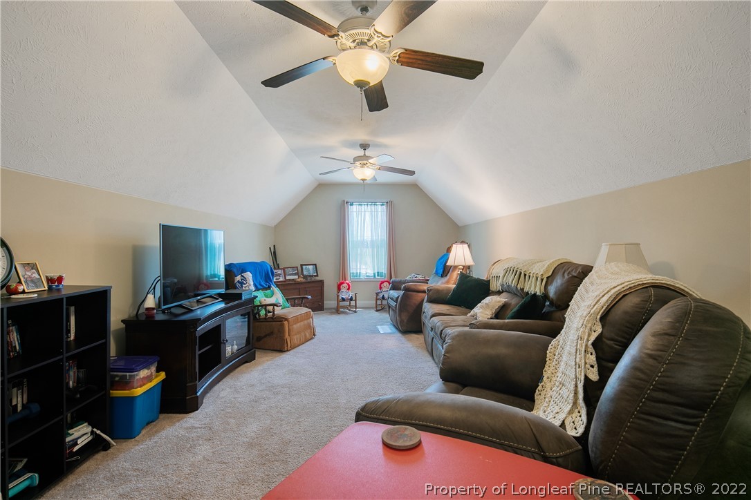 2511 Wade-Stedman Road Stedman, NC 28391 - Photo 41 of 47 a living room with furniture and a chandelier