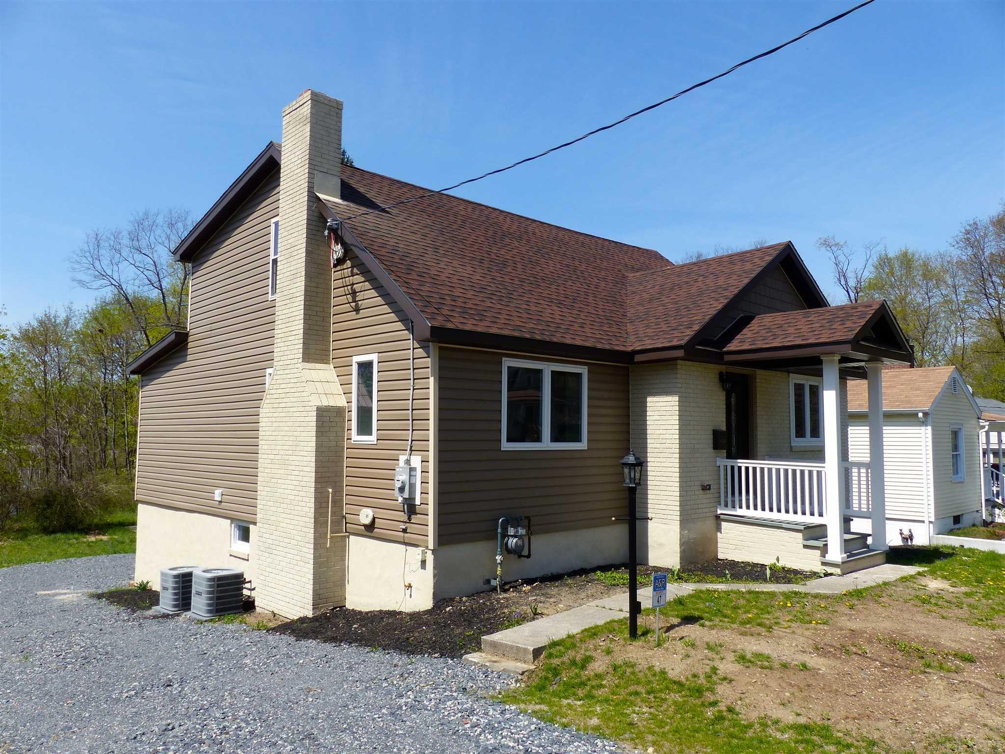 a view of house with backyard
