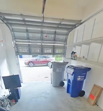 a room with water heater and wooden cabinets